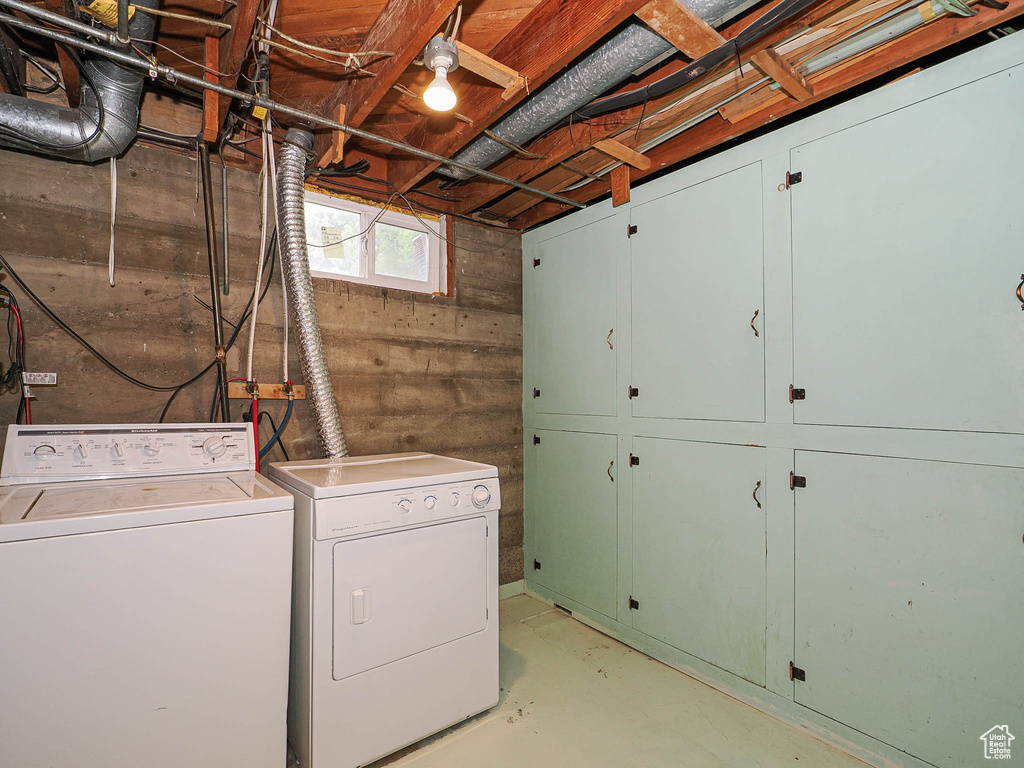 Laundry room with cabinet space and washer and clothes dryer