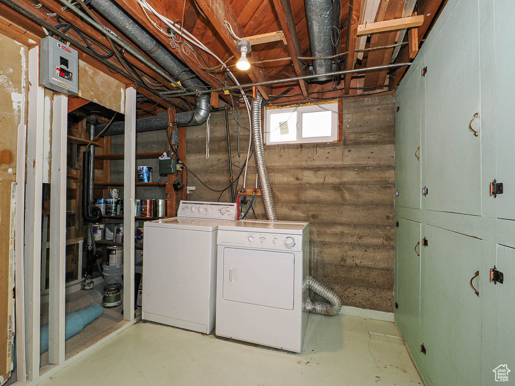 Laundry room featuring washing machine and clothes dryer and cabinet space