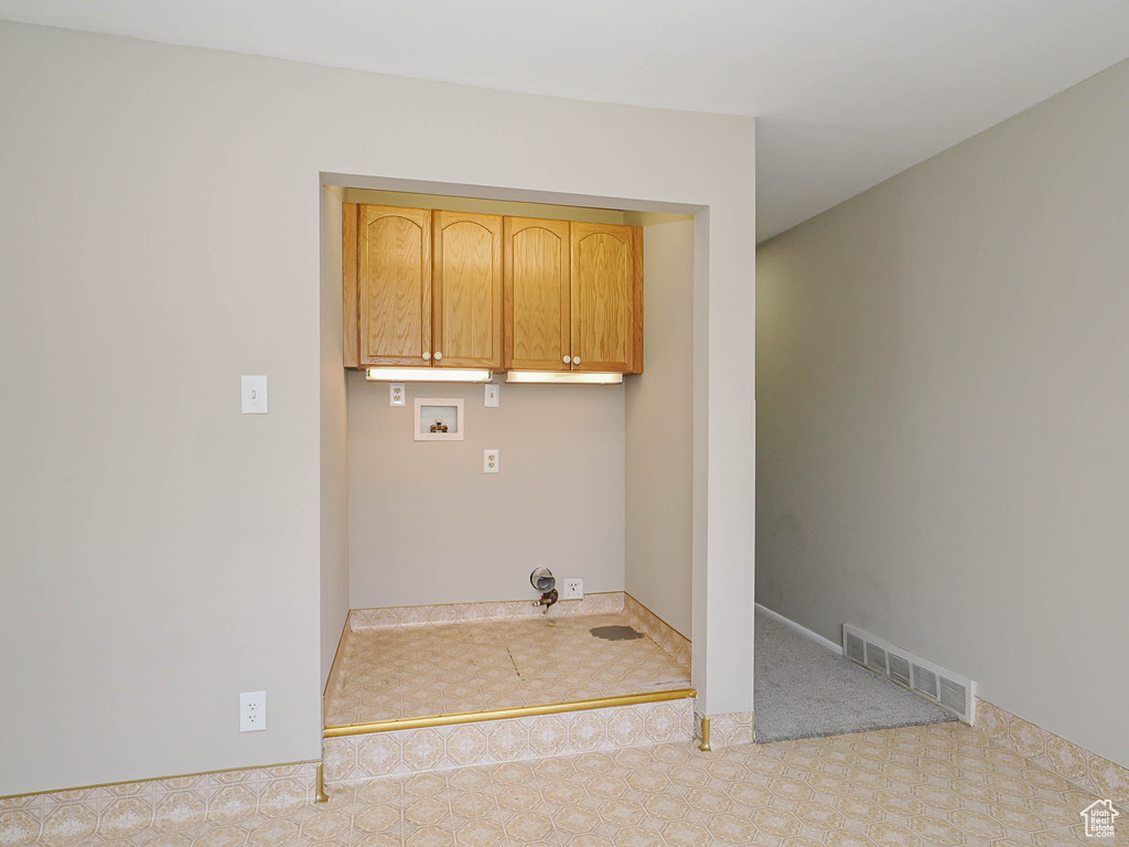 Washroom featuring cabinet space, washer hookup, and carpet floors