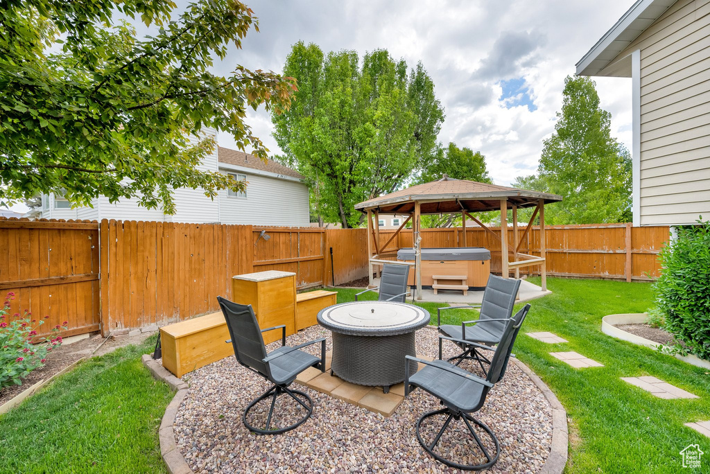 View of yard with a hot tub, a patio area, and a gazebo
