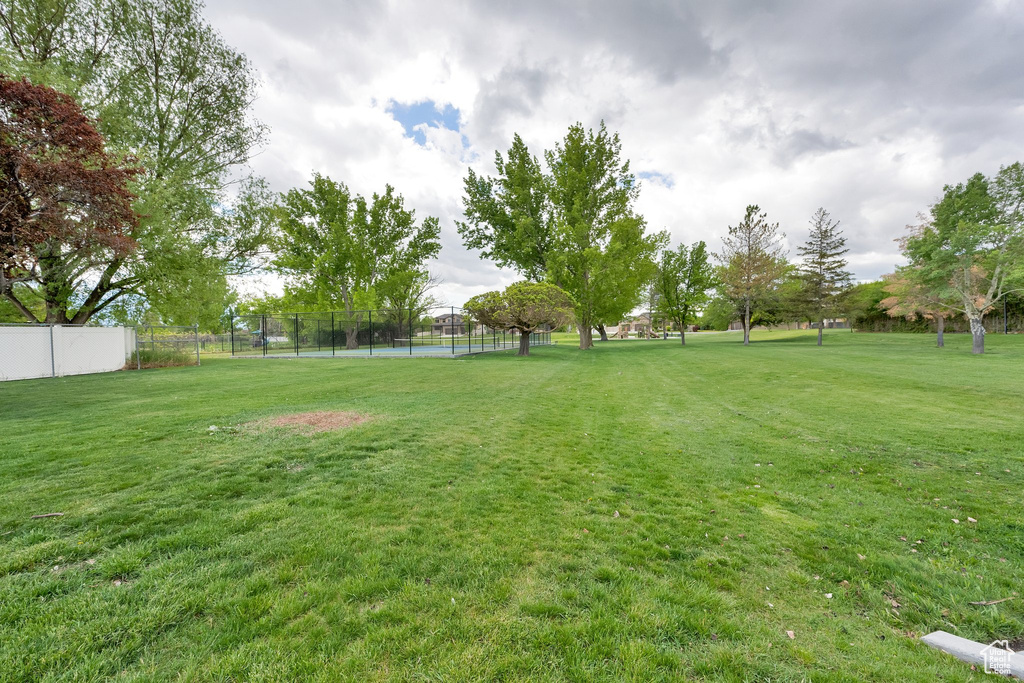 View of yard with a tennis court