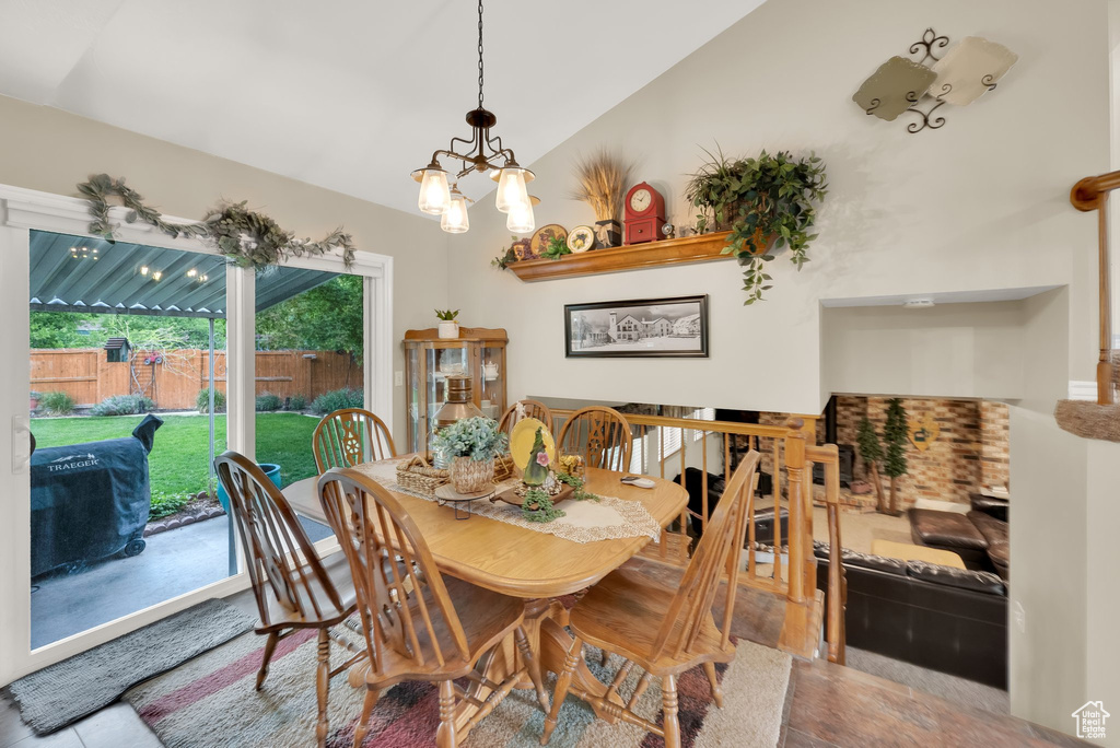 Dining space featuring a chandelier and lofted ceiling