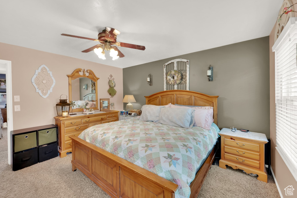 Bedroom with light carpet and ceiling fan