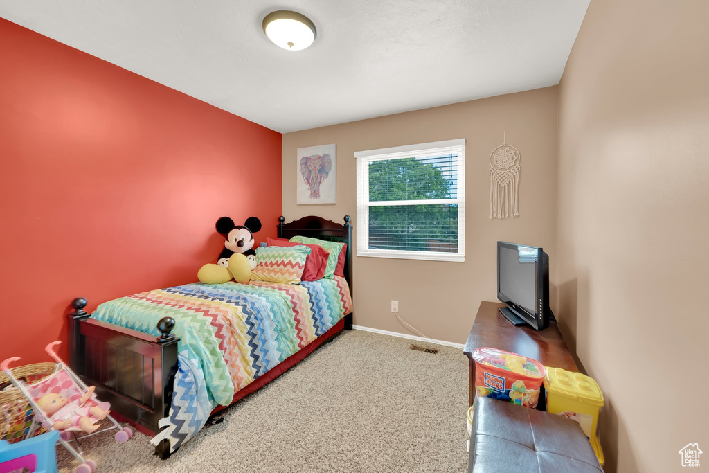 Bedroom with carpet flooring and baseboards
