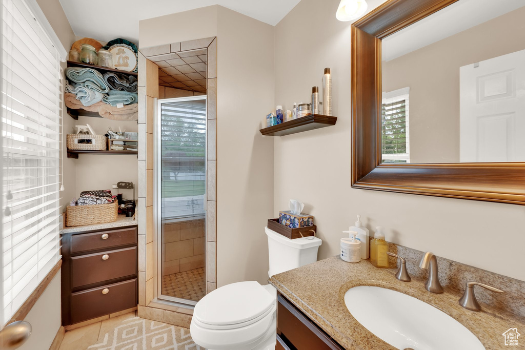 Full bathroom with a shower stall, toilet, and vanity