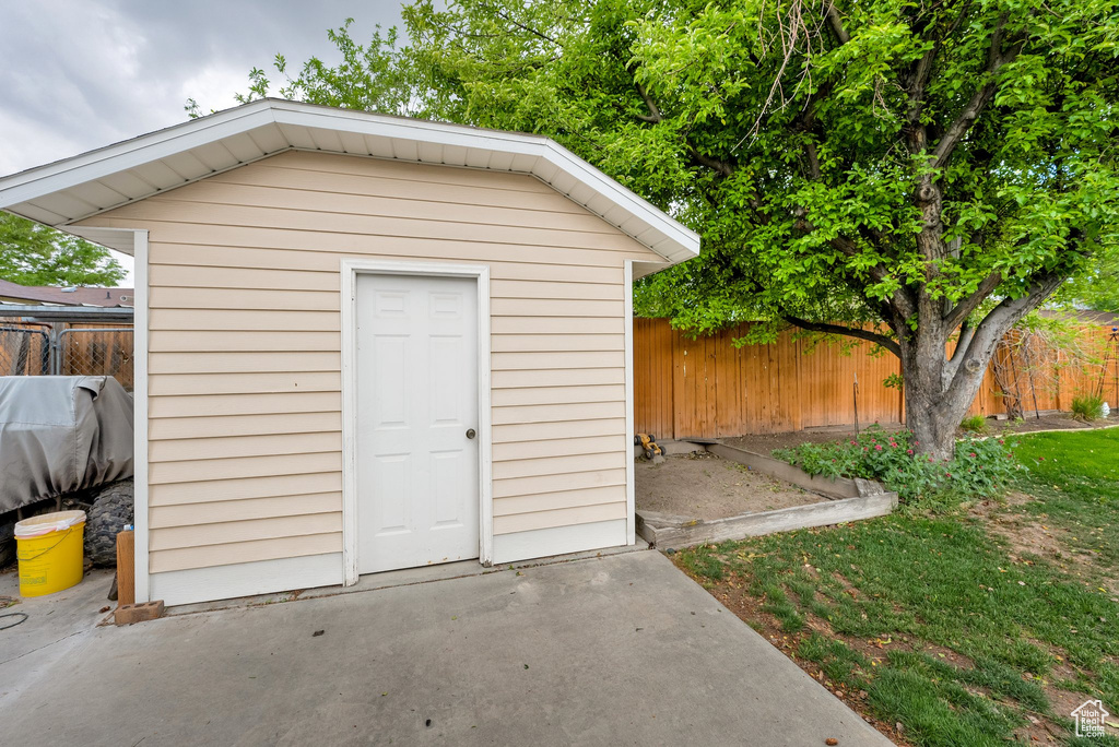 View of shed with a fenced backyard