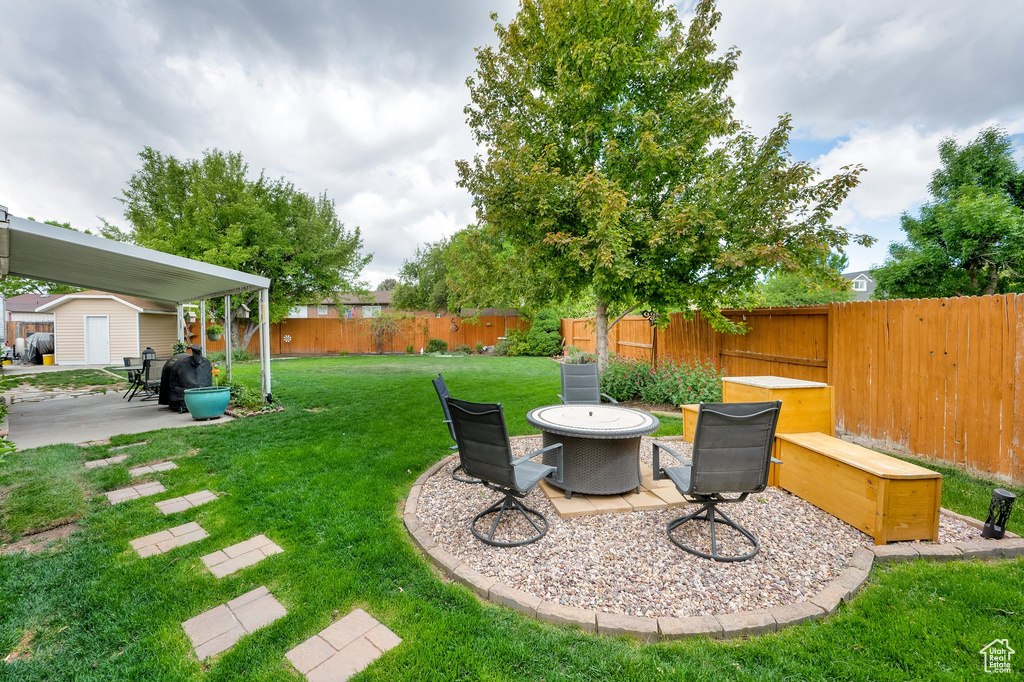 View of yard with a storage unit, a patio, and an outdoor structure