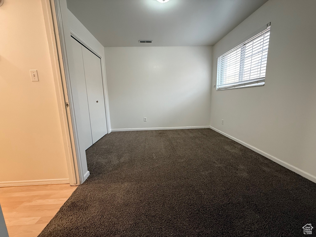Unfurnished bedroom with baseboards, a closet, and carpet floors