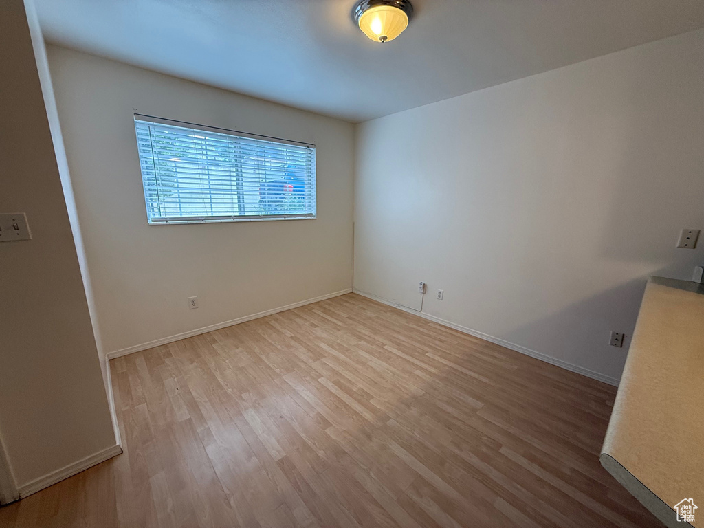 Empty room featuring wood finished floors and baseboards