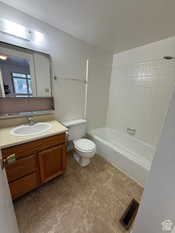 Bathroom featuring toilet, vanity, and bathing tub / shower combination