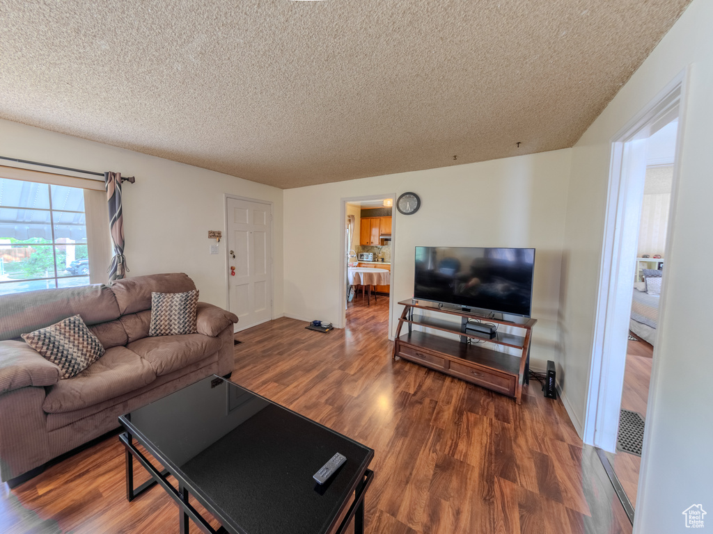 Living room featuring a textured ceiling and wood finished floors