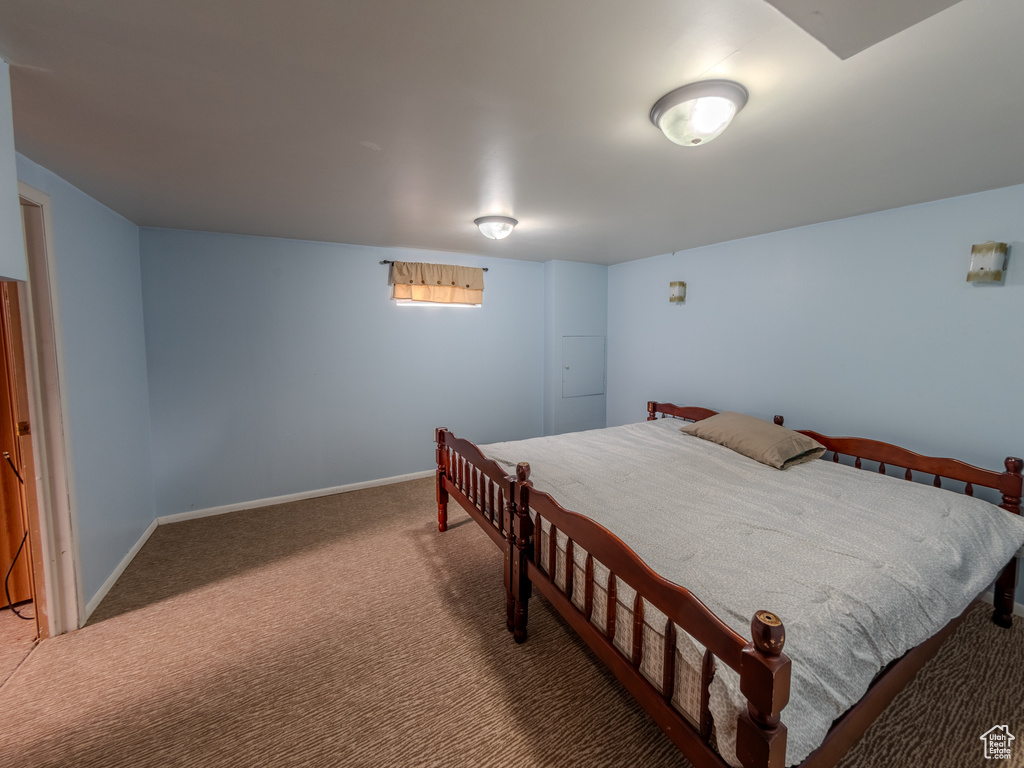 Bedroom featuring carpet floors and baseboards