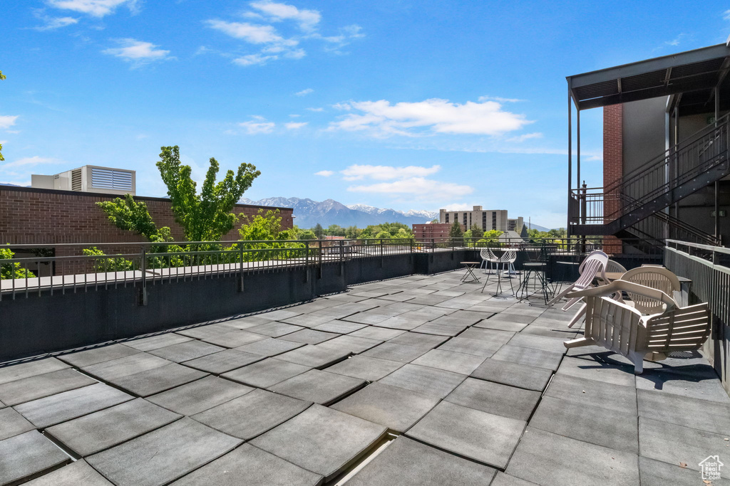 View of patio / terrace featuring a mountain view and outdoor dining space