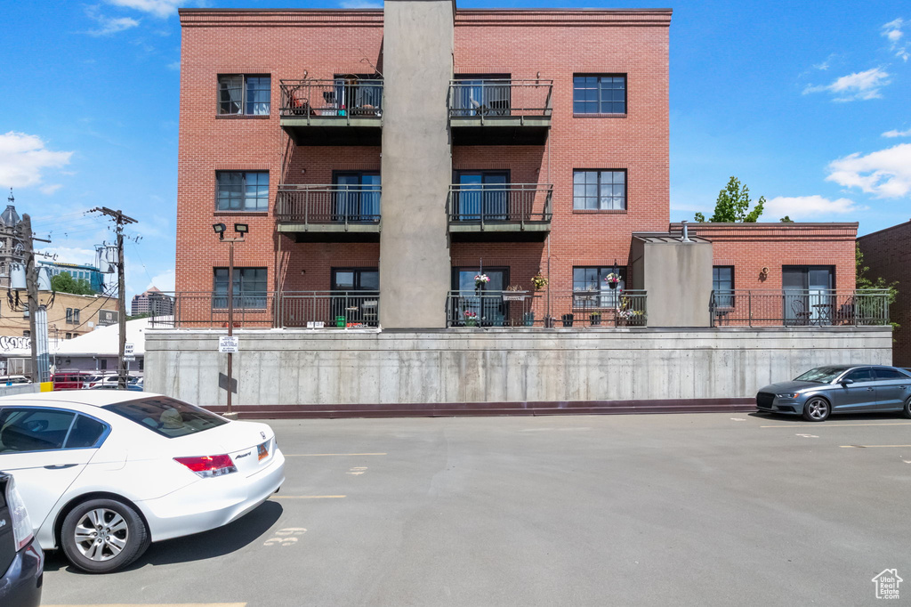 View of property with uncovered parking