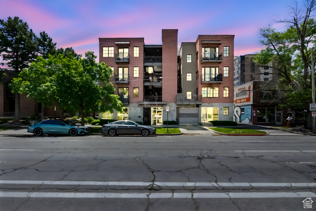 View of property at dusk