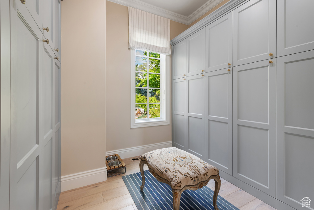 Mudroom featuring ornamental molding, baseboards, and wood finished floors