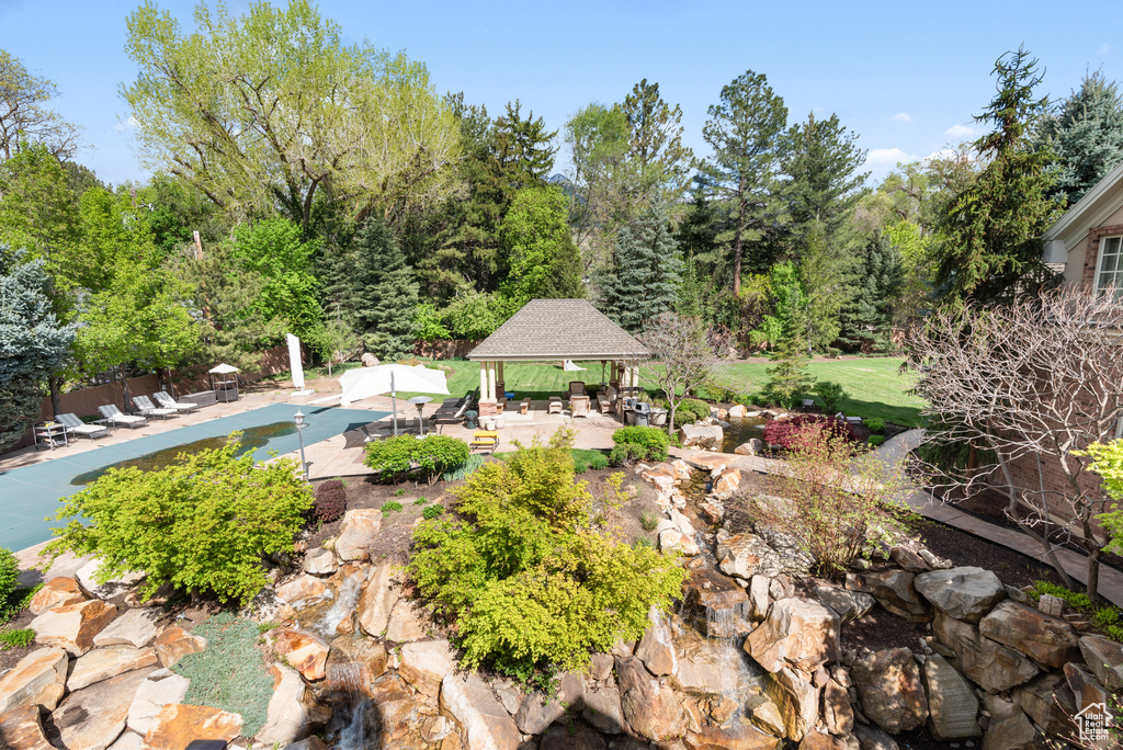View of home\\\'s community featuring a gazebo, a patio area, and a pool
