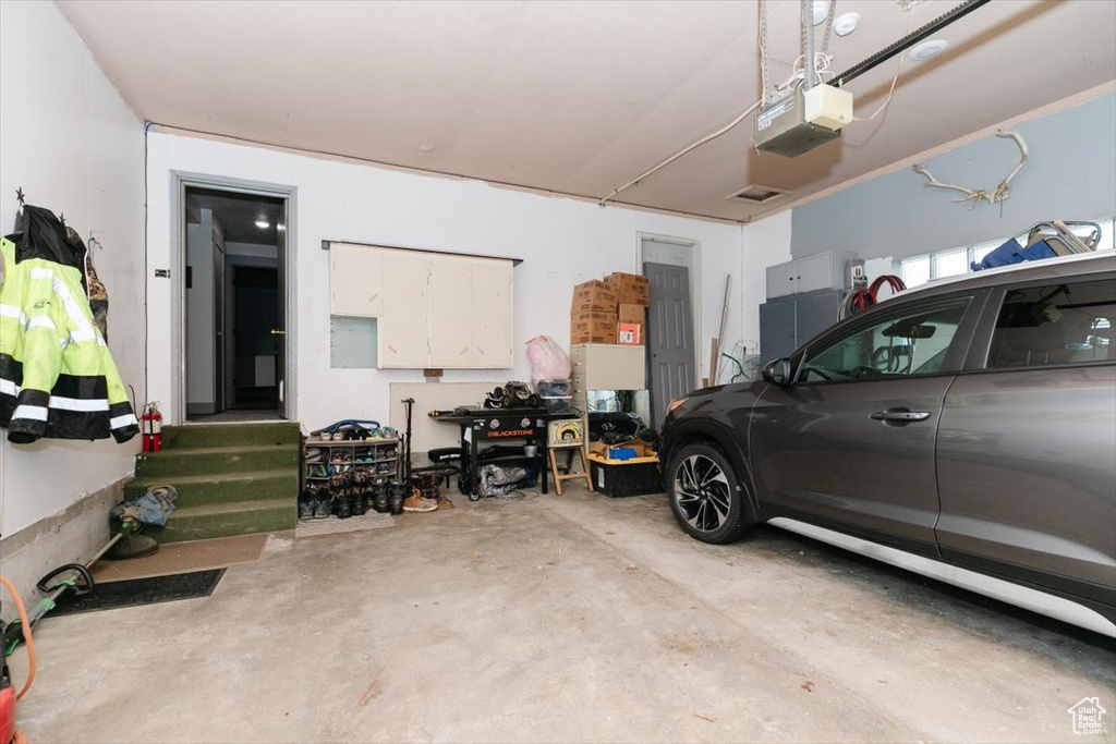 Garage featuring a garage door opener