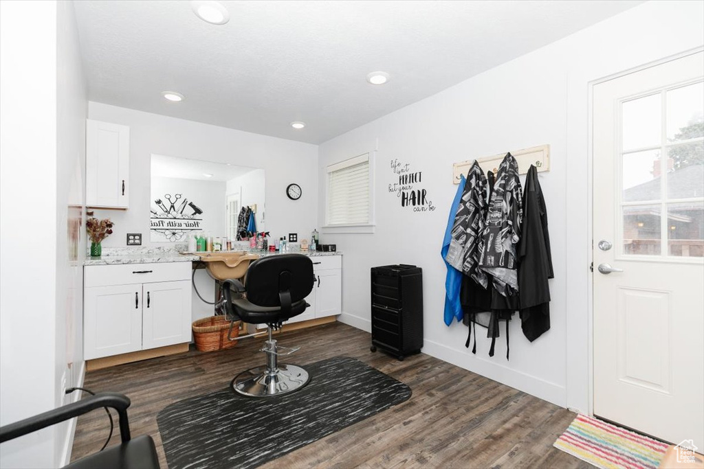 Office space with dark wood-style floors, recessed lighting, built in desk, and baseboards