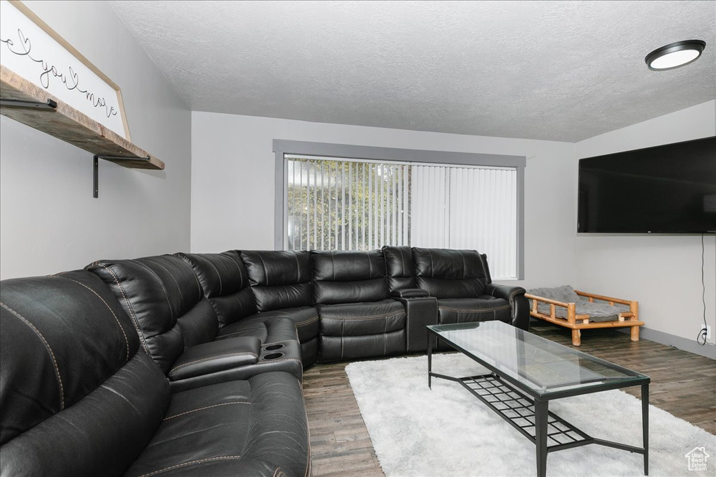 Living area with wood finished floors and a textured ceiling
