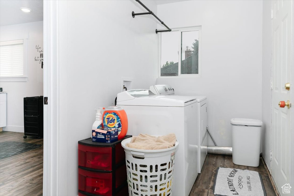 Washroom featuring washing machine and clothes dryer and wood finished floors