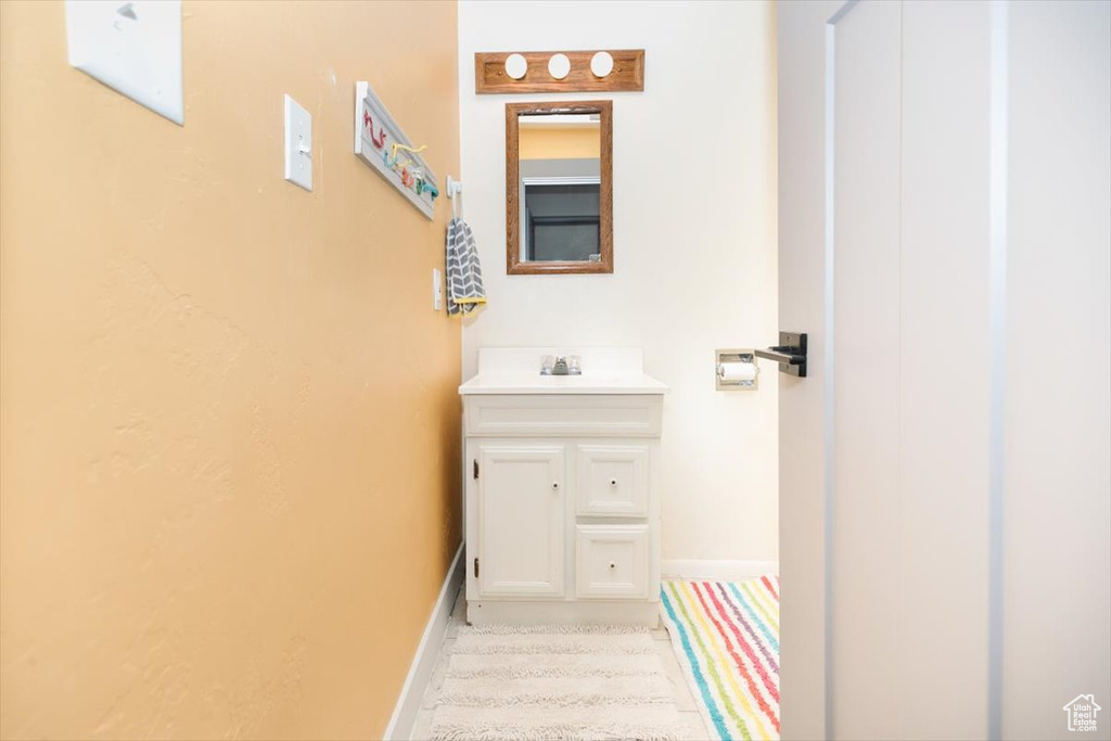 Bathroom featuring baseboards and vanity