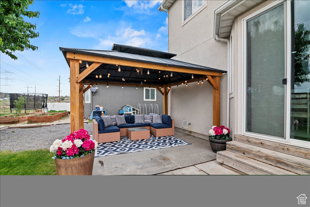 View of patio / terrace featuring an outdoor living space and a gazebo