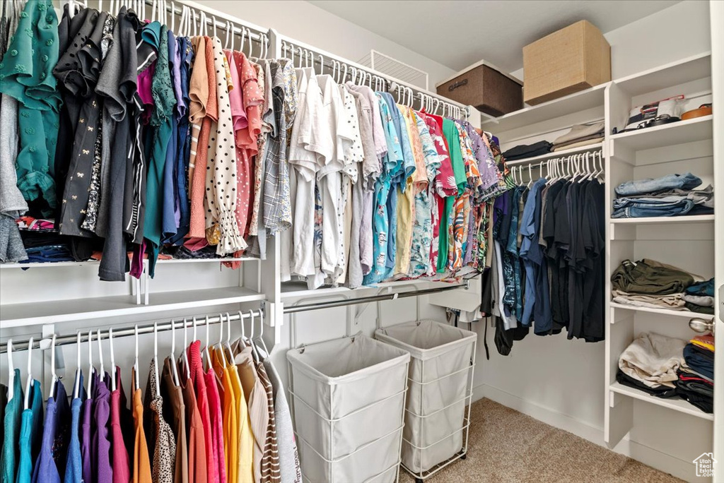 Walk in closet with carpet