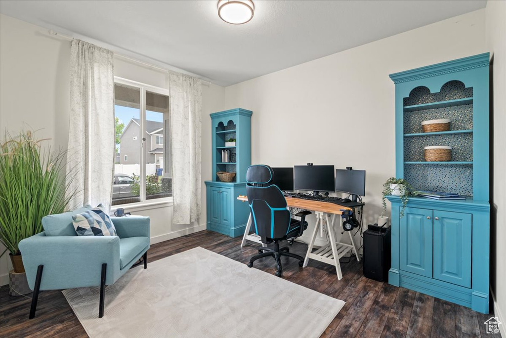 Home office featuring dark wood-style floors