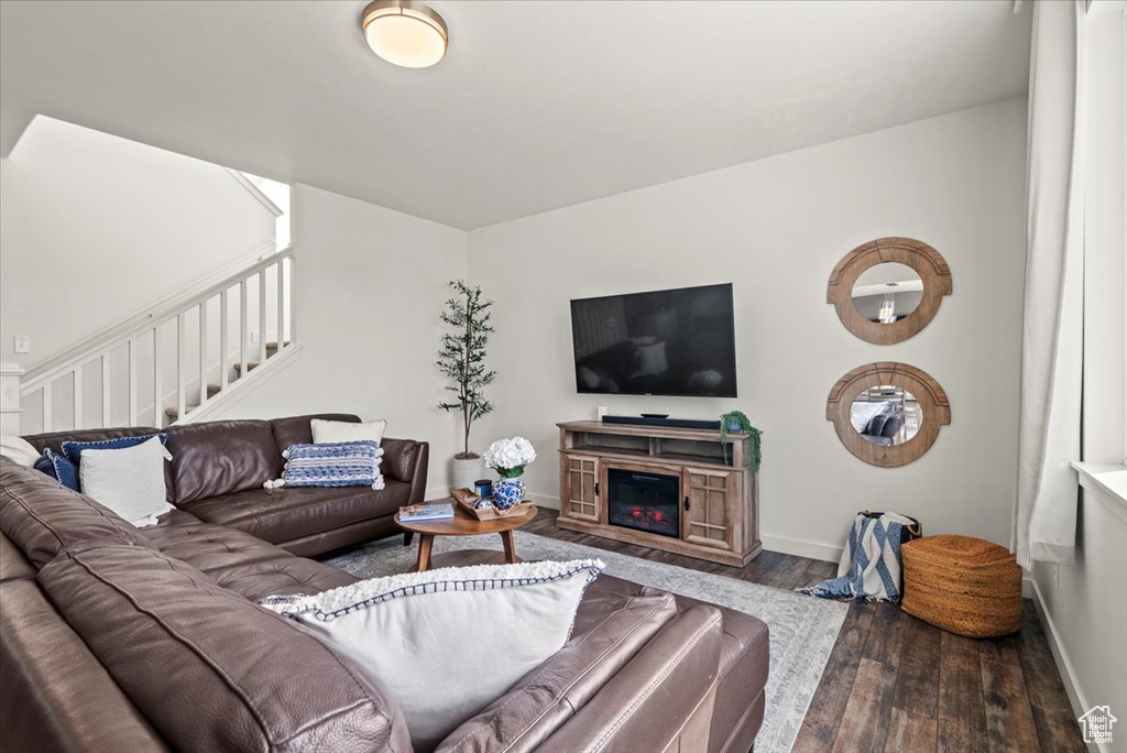 Living room with wood finished floors, stairs, and baseboards