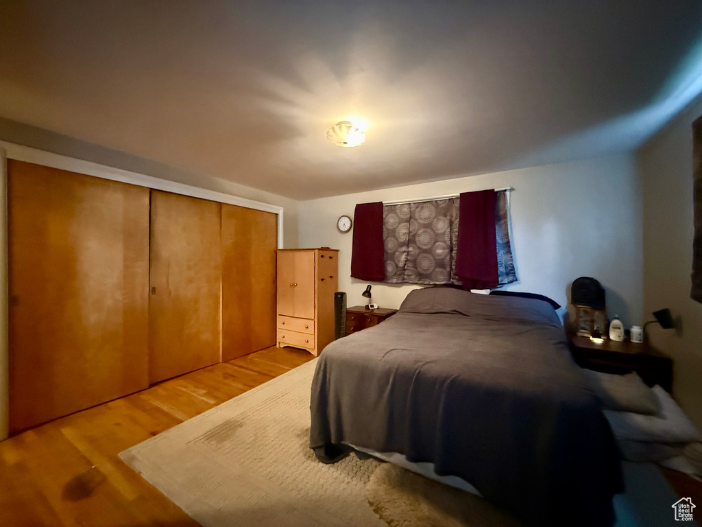 Bedroom featuring light wood-style floors and a closet