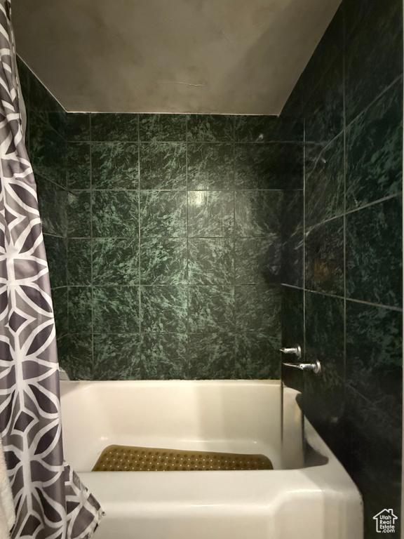 Full bathroom featuring shower / bath combination with curtain