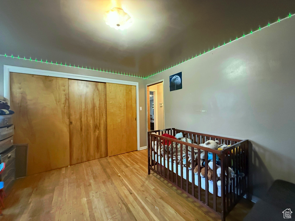 Bedroom featuring wood finished floors and a closet