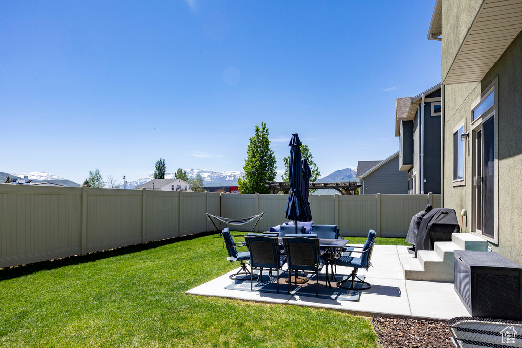 View of yard featuring a patio and a mountain view