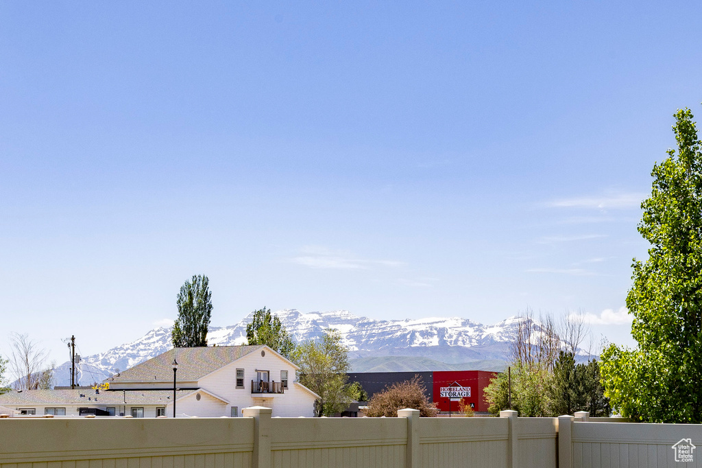 Fenced yard featuring a mountain view