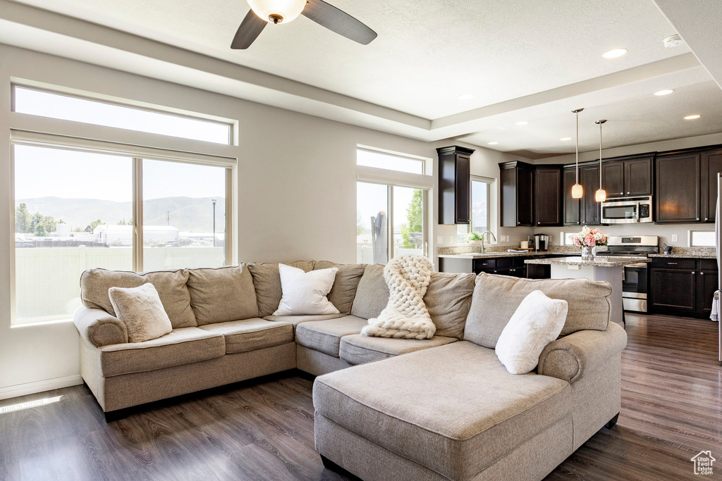 Living area featuring recessed lighting, dark wood-style flooring, ceiling fan, baseboards, and a mountain view