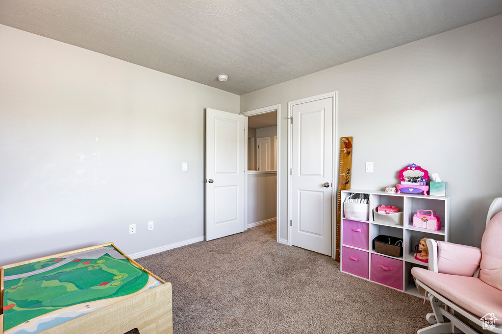 Game room featuring carpet and baseboards