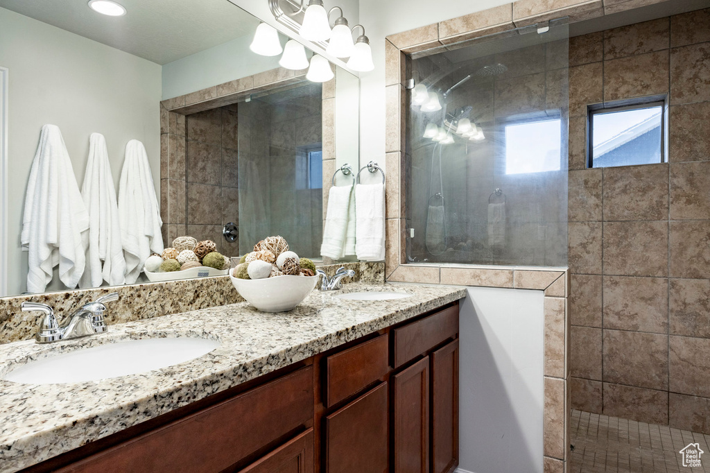 Full bathroom with a tile shower and double vanity