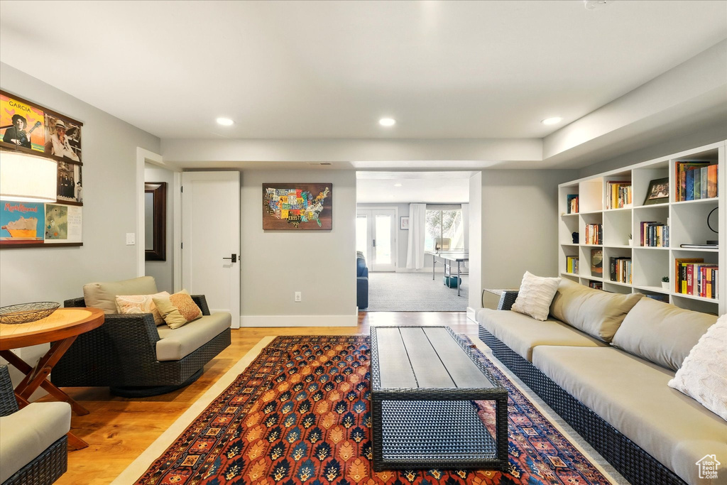 Living area with light wood finished floors, baseboards, and recessed lighting