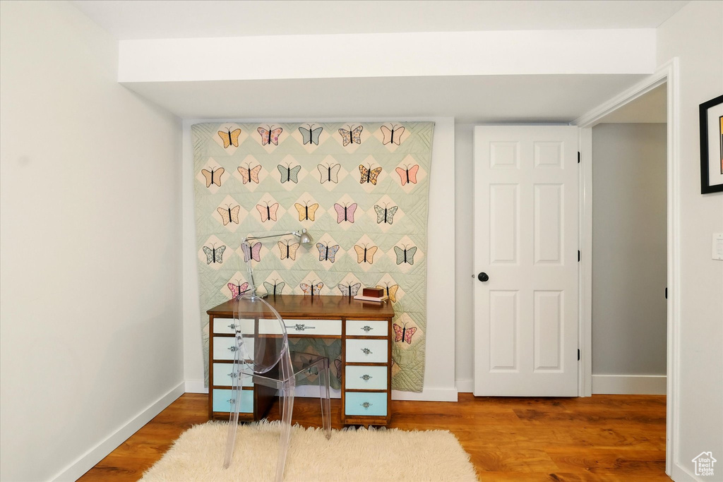 Office with wood finished floors and baseboards