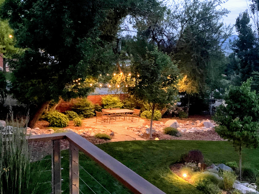 View of green lawn with a patio area