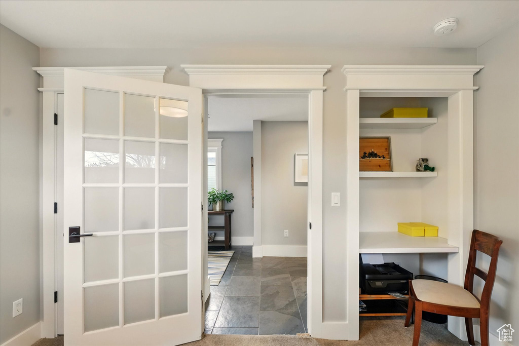 Office space featuring baseboards and stone finish floors