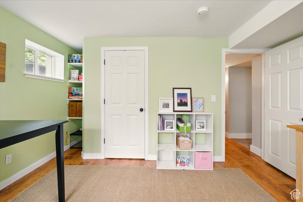 Recreation room with wood finished floors and baseboards