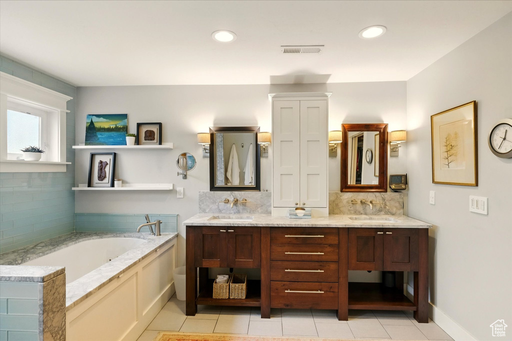 Bathroom with tile patterned flooring, decorative backsplash, double vanity, a garden tub, and recessed lighting