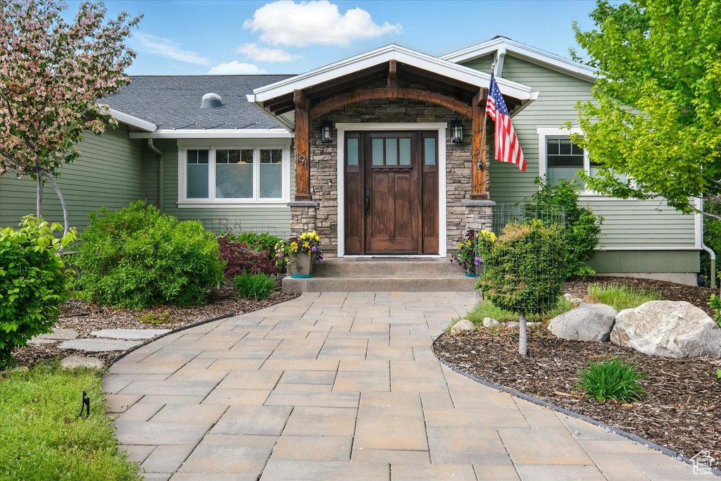 View of exterior entry featuring stone siding