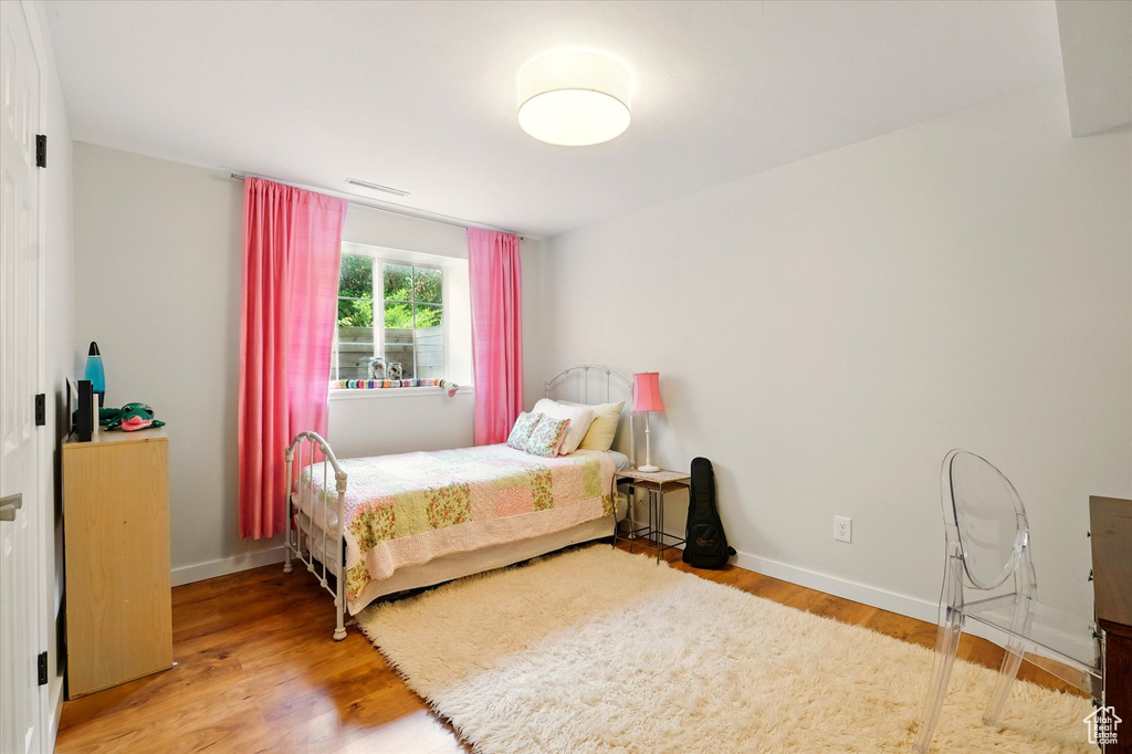 Bedroom featuring light wood-style flooring and baseboards