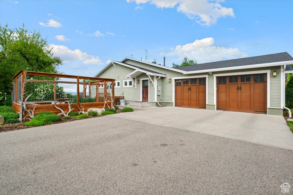 View of front of home with an attached garage and concrete driveway