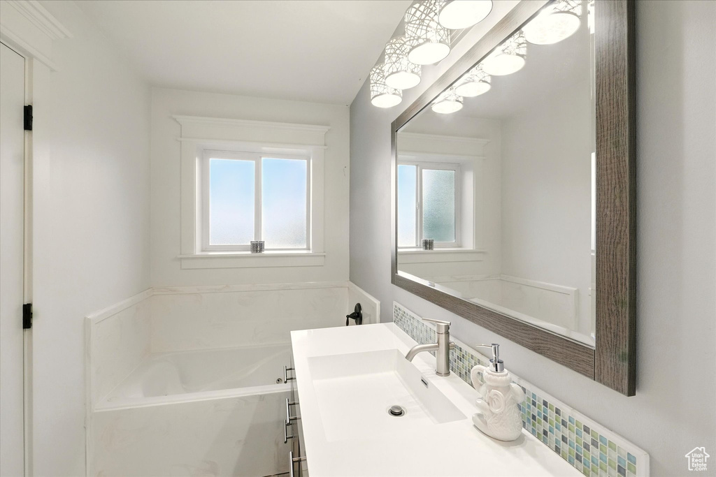 Bathroom with a bath and vanity