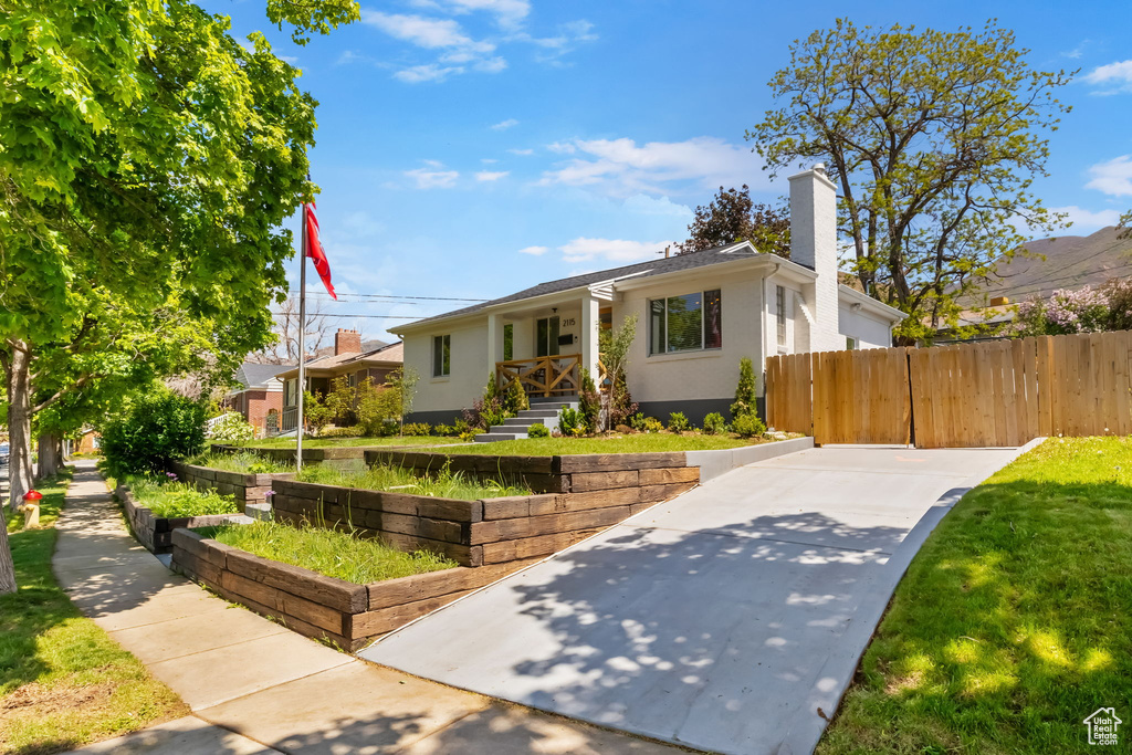 Bungalow with a chimney and fence