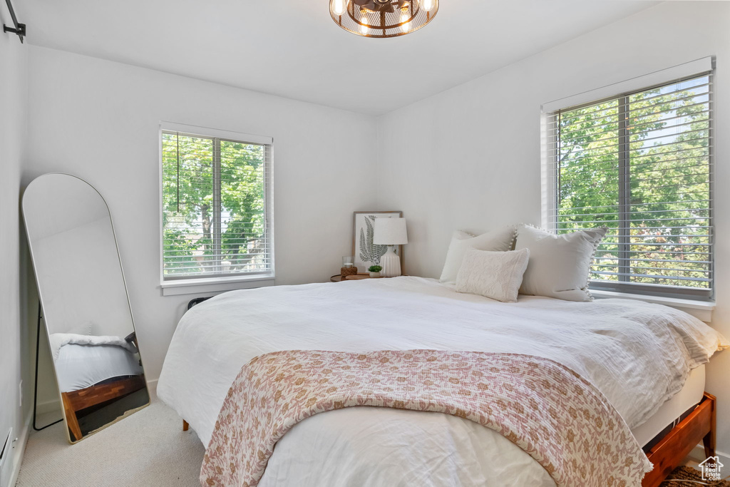 Bedroom featuring carpet and a chandelier
